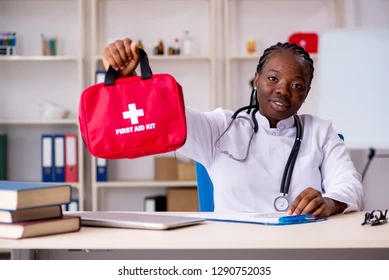 Healthcare professional holding a first aid kit